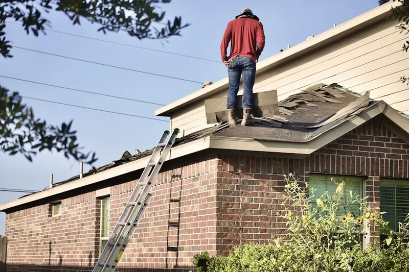 Professional roofer working on a residential roof in Tuckahoe